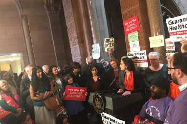 Caring majority supporters gather with protest signs