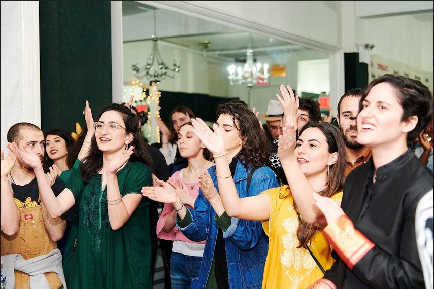 Several people are shown clapping their hands